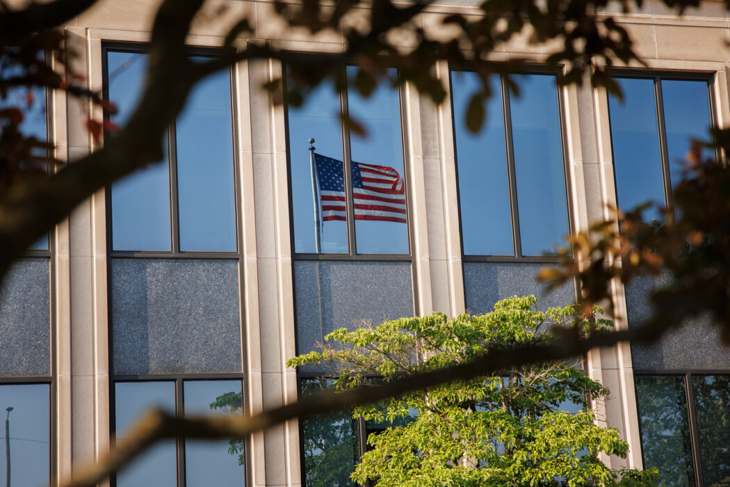 American flag reflecting on window